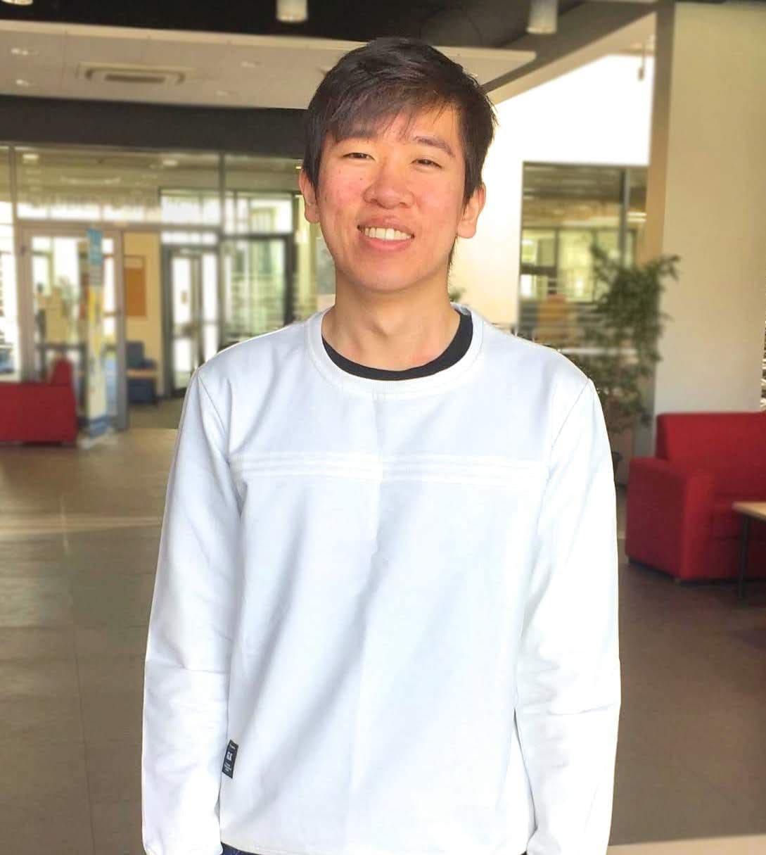 Uno smiling in a white sweatshirt